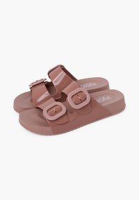 Rose-colored sandals made of glossy plastic, featuring two adjustable buckles on wide straps and a textured footbed for grip.