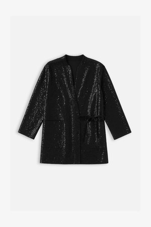 Veste noire à manches longues avec texture en sequins, devant ouvert, sans col, deux poches et ceinture à nouer pour la fermeture.