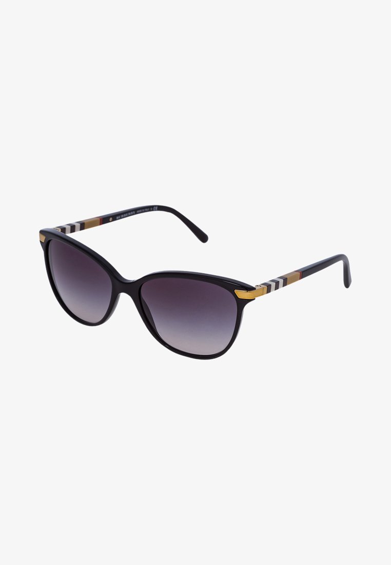 Gafas de sol negras de gran tamaño con lentes degradados de gris oscuro. Las monturas presentan un diseño a rayas multicolor y un acento dorado en las patillas.