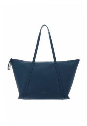 Sac cabas en cuir bleu marine avec longues poignées, fermeture éclair et logo "Coccinelle" doré discret au centre avant.