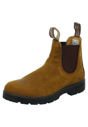 Brauner Lederknöchelstiefel mit elastischem Seitenpanel, runder Zehenform und Schlaufe zum einfachen An- und Ausziehen. Gummisohle in Schwarz mit Profil für besseren Halt.