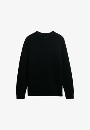 Sort striktrøje med ribbestrikket rund hals, lange ærmer og tekstureret stof. Har et diskret logo på brystet. enkelt design.