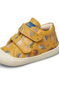 Žluté kožené boty se vzorem dinosaurů, suchými zipy a texturovanou gumovou podrážkou. Měkká vnitřní podšívka pro pohodlí.