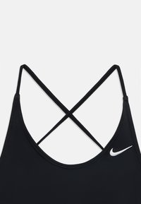 Soutien-gorge de sport noir avec un design à dos croisé. Fabriqué en tissu lisse, avec un petit logo Nike blanc sur le côté gauche. Style simple et fonctionnel.