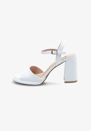 White high-heeled sandals with a thick block heel, open toe, curved front strap, and adjustable ankle strap in smooth synthetic material.