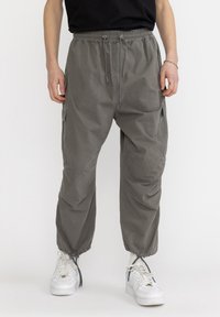 Lichte, grijze cargobroek met een verstelbare trekkoord in de taille en elastische manchetten; beschikt over zijzakken en een soepele stoftextuur.
