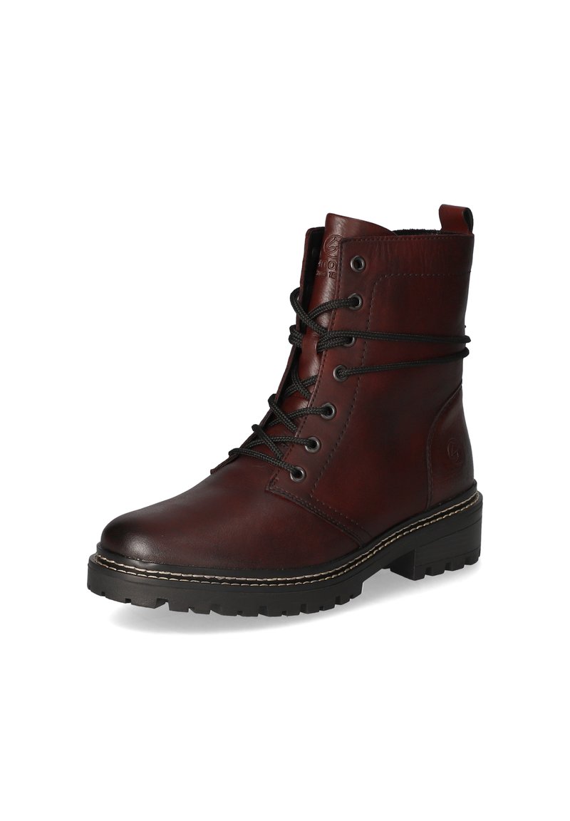 Bottines en cuir marron à lacets avec une pointe arrondie, surface texturée, lacets noirs et semelle en caoutchouc robuste.