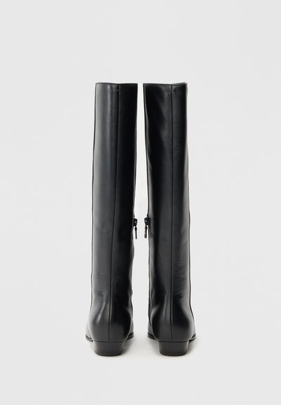 Čierne kožené čižmy po kolená s hladkou textúrou, štíhlym siluetom a zadnými zipsami. Nízke blokové opätky pre stabilitu.