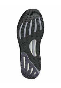 Black athletic shoe sole with textured rubber, featuring deep treads for traction, white accents, and a groove design for flexibility.