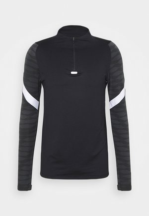 Haut de sport noir à manches longues avec manches subtilement ornées d'un motif, bandes diagonales blanches sur le haut des bras, et col à quart de fermeture éclair avec languette de tirage à l'avant.