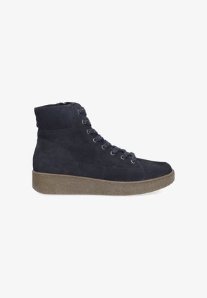 Navy suede ankle boots with a textured brown platform sole, featuring metal eyelets and lace detailing on the front.