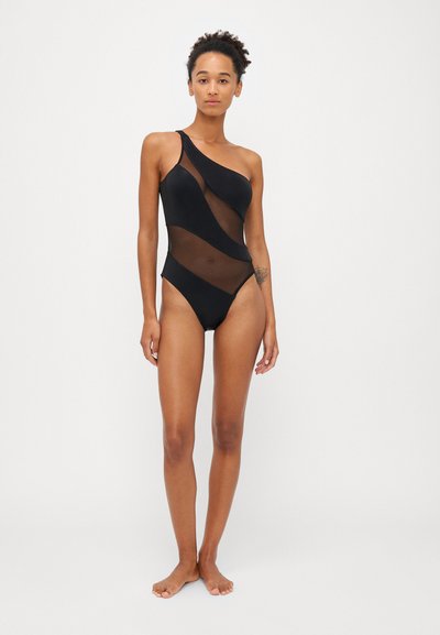 Schwarzes Einteilerswimwear mit einem einseitigen Design, durchsichtigen Mesh-Einsätzen und einem hohen Beinausschnitt, der eine Kombination aus glatten und strukturierten Materialien bietet.