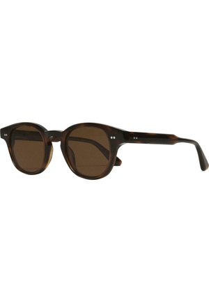 Lunettes de soleil rondes avec une monture en écaille de tortue, des verres marron et des points métalliques à l'avant. Les montures ont des bords lisses et une finition brillante.