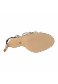 Zilveren hoge hak sandaal met een met kristallen versierde band, een gladde beige zool en een slanke, taps toelopende hak.
