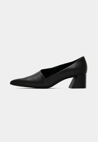 Black leather pump with a pointed toe and a triangular block heel. Smooth texture, minimalistic design with an open side for breathability.