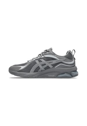 Gray and black athletic running shoe with white logo stripes, cushioned sole labeled "FlyteFoam," and lace-up design.