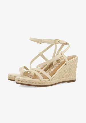Bež espadrille wedge sandale imajo pleteni juten peto, več križnih trakov in zaponko na gležnju.