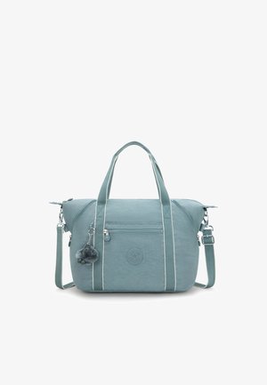 Teal fabric handbag with white stripes, two handles, detachable shoulder strap, front zip pocket, and a furry keychain accessory.