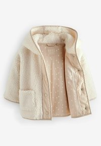 Crème-kleurige fleecejas met een capuchon, voorzien van een voering met stippenpatroon en een patches pocket aan de voorkant. Zachte textuur.