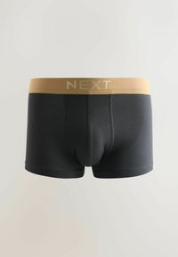 Boxers pour hommes noirs avec une large ceinture beige portant le nom de la marque "NEXT" au centre.