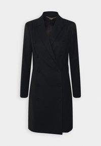 Svart dubbelknäppt kappa med långa ärmar, snedskurna revers och strukturerad väv. Har framträdande knappar och rak skärning.