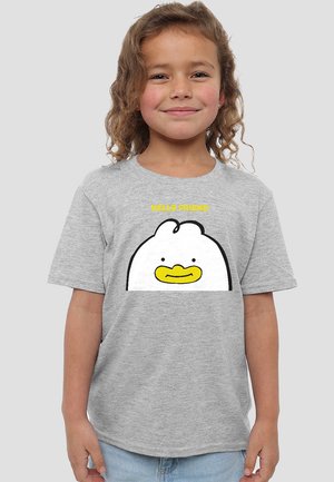 Smiling young child with curly hair wearing a gray t-shirt featuring a cartoon chicken face and yellow text "HELLO FRIEND."