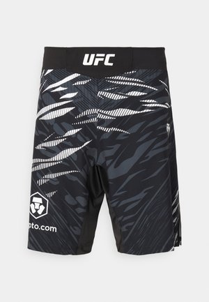 Mustad mustus sportlikud lühikesed püksid, millel on dünaamiline monokroomne muster, UFC logo ehk spordiga seotud logo vööl ja kontrastsed graafikad külgedel.