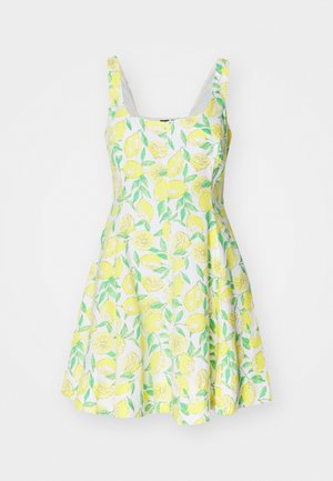 Lemon-patterned sleeveless dress made of light fabric, featuring a flared skirt and a white background with green leaves and yellow lemons.