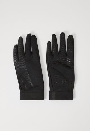 Black athletic gloves made of textured fabric, featuring a fitted design, silicone accents for grip, and a seamless wrist cuff.