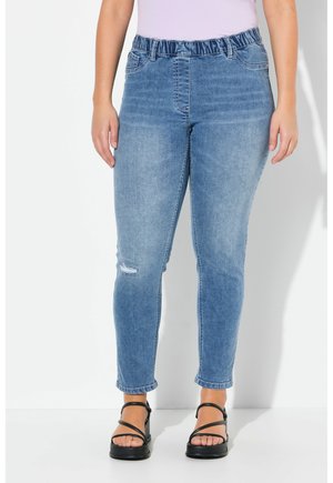 Light blue denim jeans with an elastic waistband, slim fit, and ankle-length cut. Features a distressed patch on the left thigh.