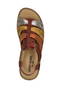Multicolored sandal with red, orange, yellow, and silver leather straps. Features an open toe design and a cushioned insole for comfort.