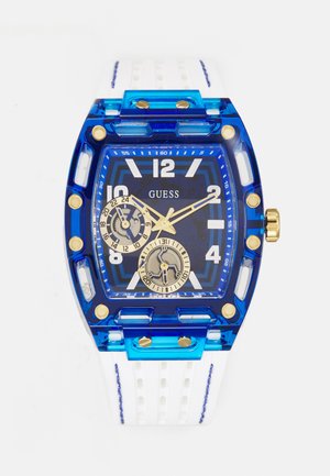 Orologio in acrilico blu e trasparente con quadrante quadrato, cinturino in gomma bianca, dettagli dorati e doppio sottocinturino per la visualizzazione dell'ora e della data.