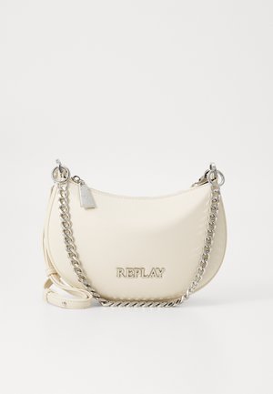 Sac à main couleur crème avec une finition lisse, bandoulière en chaîne argentée et un détail de logo. Forme incurvée, fermeture éclair et bandoulière détachable.
