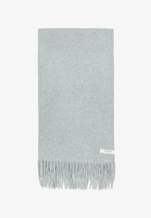 Light gray woolen scarf with fringed ends and a small white label reading "COMMA est. 1973" on one side.