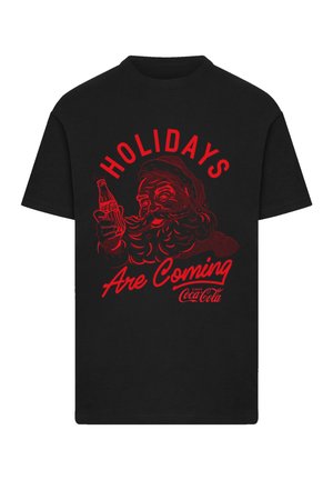 Black cotton t-shirt featuring a red graphic of Santa holding a Coca-Cola bottle with the text "HOLIDAYS Are Coming" above.