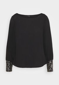 Blusa nera con scollo rotondo e maniche lunghe. I polsini sono decorati con un motivo di paillettes luccicanti, che aggiungono contrasto al tessuto.