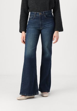 Dark blue flared jeans with a high waist, made of denim. Features a classic five-pocket design and subtle fading towards the hem.