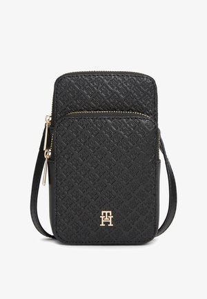 Borsa a tracolla in pelle nera con motivo in rilievo, ferrature dorate e chiusura con zip. Presenta una tracolla sottile regolabile e un dettaglio con logo.