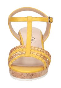 Yellow wedge sandals with a braided strap design, a transparent ankle strap, and a cork-textured heel. Flat rubber outsole for grip.