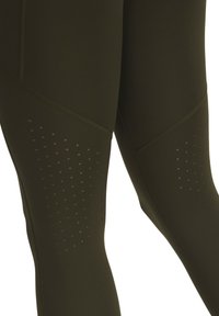 Olive green leggings with a smooth texture, featuring perforated detailing on the lower leg and curved seam accents for enhanced fit.