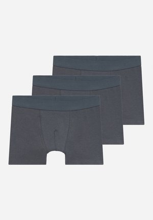 Tre mørkegrå boxer shorts med brede elastiske taljebånd, anbragt overlappert på en hvid baggrund.