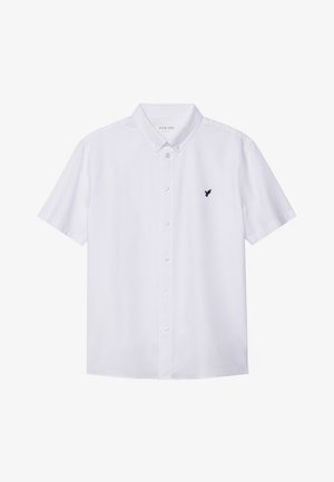 White short-sleeve shirt made of cotton, featuring a button-down collar and a small black bird emblem on the left chest.