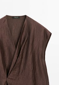 Brown textured sleeveless wrap dress with deep V-neck and a Massimo Dutti label inside the collar.