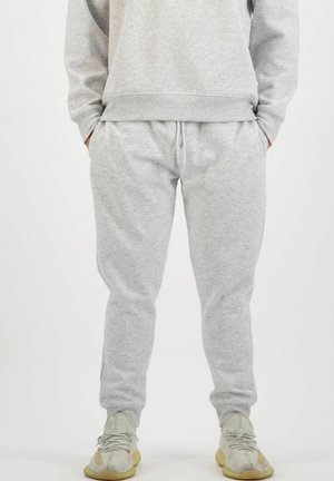 Gray sweatpants with elastic waistband, side pockets, and cuffs at the ankles. Made of soft, textured fabric for comfort and ease.