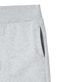 Pantalones de chándal grises con una tela suave y texturizada. Cuentan con una cinturilla elástica y bolsillos laterales, con un diseño sencillo de pierna recta.