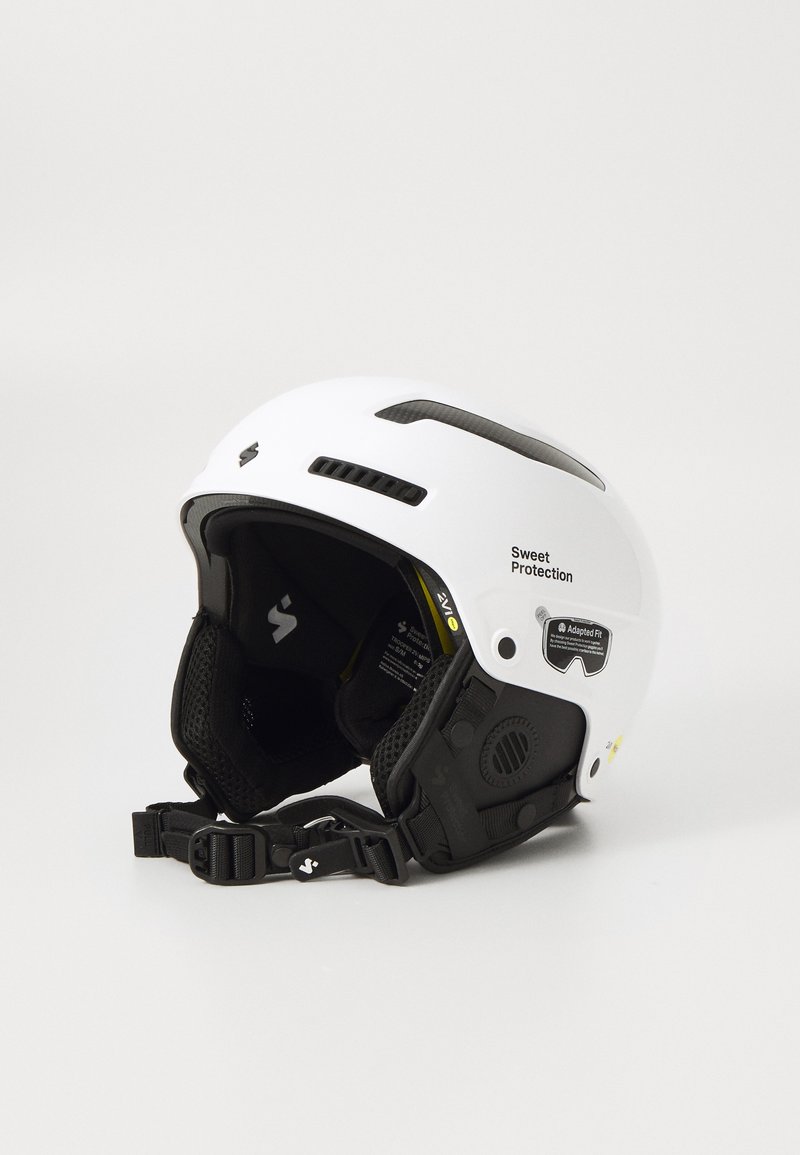 White ski helmet with black accents, adjustable chin strap, ventilation slots, and logos. Smooth finish, lightweight design, ergonomic fit.