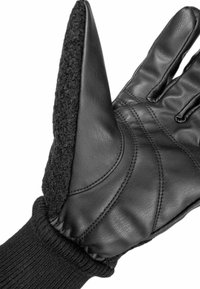 Schwarze Lederhandschuhe mit einem strukturierten schwarzen Stoffeinsatz und geripptem Strickbund. Die Handfläche hat Nähdetails, die den Halt und die Flexibilität verbessern.