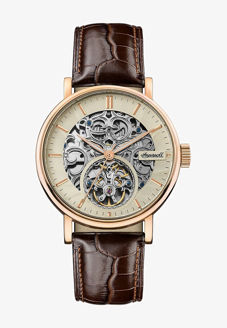 Automatic watch with a silver-toned skeleton dial. Features rose gold-tone case, brown textured leather strap, and decorative accents.