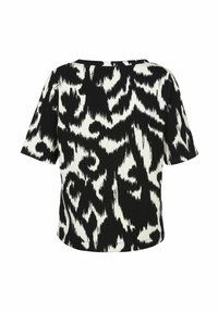T-shirt à manches courtes avec un motif abstrait noir et blanc, encolure ronde, coupe décontractée et tissu doux et texturé.