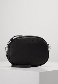 Borsa a tracolla in pelle nera con forma ovale arrotondata, superficie testurizzata, hardware in argento e tracolla removibile.